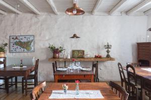 a dining room with wooden tables and chairs at WUNDERGARTEN Dimora dei Frati in Gratteri