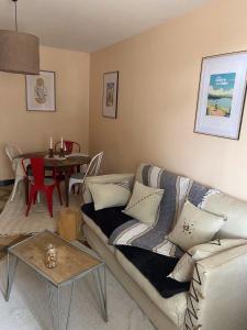 a living room with a couch and a table at les petits sportifs in Léré