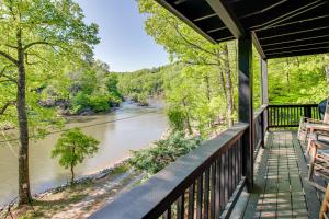 a balcony with a view of a river at The River Rest Ellijay Cabin with Hot Tub! in Ellijay