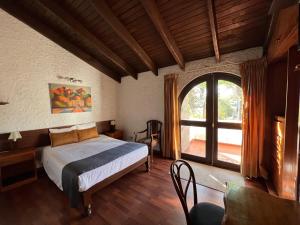 a bedroom with a bed and a large window at Hotel La Casa de Tin tin in Arequipa