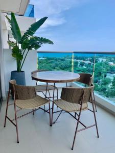 a table and two chairs and a table and a window at SAMARIA CLUB DE PLAYA by Santa Marta Playa Resort, Preciosos Apartamentos en el sector exclusivo de Pozos Colorados in Santa Marta +59 photos