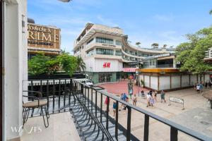 a group of people walking in front of a building at Best Spot on 5th Ave - 2BR with King Beds & Style in Playa del Carmen