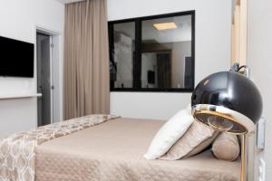 - une chambre avec un lit et un casque dans l'établissement Guaja - 745 - Amora Mel Apartamento, à Belo Horizonte 9 autres photos