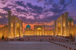 a large building with a sunset in the background at Anoras home in Samarkand