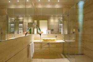 a bathroom with a large mirror and a large tub at Grand Hotel Minerva in Florence