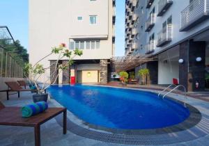 a large blue swimming pool in the middle of a building at Nagoya Mansion Apart Trw B in Nagoya +27 photos