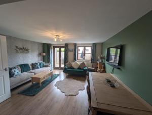 a living room with a couch and a table at Purdie Close Holiday Let in Cheddar