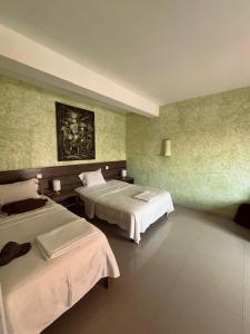 a hotel room with two beds in a room at Vivenda Viviani in Praia +57 photos