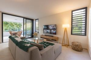AvaeMaraea Deluxe Apt 2BR 2BA with Pool View near Tahiti Airport的带沙发和桌子的客厅