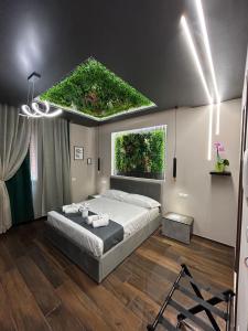 a bedroom with a large bed with a green roof at La Dimora del Re in Rome