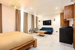 a bedroom with a bed and a couch and a table at Alma Apart Residence in Cannes
