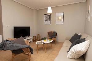 a living room with a couch and a tv at El Bosque del Sapo in El Pueyo de Jaca