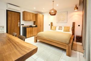 a bedroom with a bed and a wooden table at Alma Apart Residence in Cannes