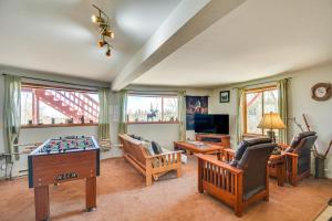 a living room filled with furniture and a table at Fairplay Cabin with Mtn View about 4 Mi to Platte River! in Fairplay