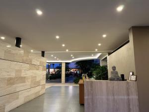 a lobby of a building with a statue on a counter at Casa Begonias Hotel mas Villas in Jiutepec +38 photos