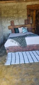 a bedroom with a bed in a log cabin at Chale do guerreiro in Coroas +60 photos