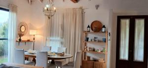 a dining room with a table and chairs and a window at La Mora Home - Casa de Campo in Victoria