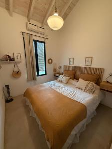 a bedroom with a large bed in a room at La Mora Home - Casa de Campo in Victoria +22 photos