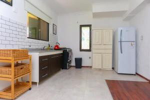 a kitchen with a white refrigerator in a room at Casa Quinta Los Molinos 1912 in Estación Las Flores