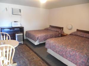 Säng eller sängar i ett rum på Ute Motel
