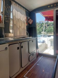 an rv kitchen with a view of a balcony at Douro Houseboats in Várzea do Douro