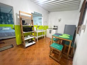 a room with a kitchen and a bathroom with a sink at Tunco Bambú Room 1 in Tamanique