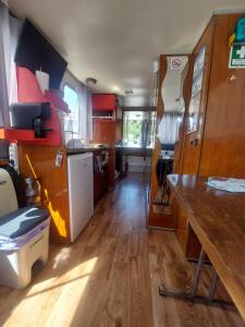 a kitchen and dining area of an rv at Douro Houseboats in Várzea do Douro +37 photos