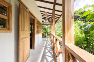 a hallway of a house with wooden doors at Villa Piňa dorada dependencia del hotel Casa Merlin in Puerto Viejo