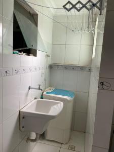 a bathroom with a toilet and a sink at Alugo apartamento COP 30 in Ananindeua