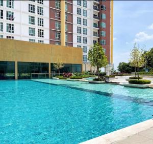 a large swimming pool in front of some tall buildings at Studio at Mesahill Nilai by D'KAY HOMES with Mall, near USIM KLIA in Nilai