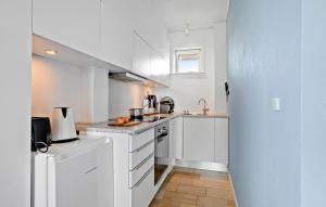 a white kitchen with white cabinets and a sink at Stunning Home In Allinge With Wifi in Allinge