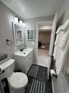 a bathroom with a white toilet and a sink at North Bethesda Gem - Entire House 5 min from Metro in Rockville