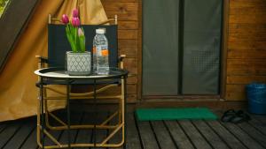 a table with a bottle of water and flowers on it at Sumiran Eco Park & Resort in Kuching