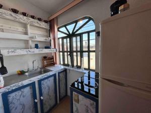 a kitchen with a sink and a refrigerator at A mini apartment in Cuernavaca, in a good location in Cuernavaca