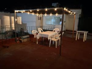 a patio with a table and chairs and lights at A mini apartment in Cuernavaca, in a good location in Cuernavaca