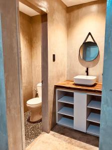 a bathroom with a sink and a mirror on a counter at Beach People Hostel Bantayan Island in Ocoy +32 photos