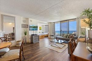a living room with a couch and a table at Sky-High Oceanview Escape at Waikiki Banyan with Free Parking (23214) in Honolulu