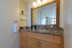 a bathroom with a sink and a large mirror at Sky-High Oceanview Escape at Waikiki Banyan with Free Parking (23214) in Honolulu +18 photos