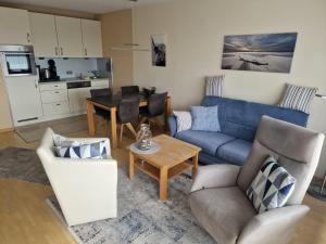a living room with a blue couch and a table at Germania-46 in Böhl