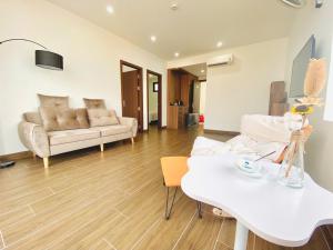 a living room with a couch and a table at DOLPHIN hotel Thiên Cầm in Cẩm Xuyên