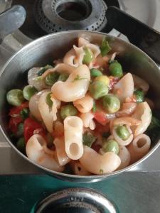 a pan filled with pasta and vegetables on a stove at Hotel Abhi family guest house in Lucknow