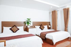 Rúm í herbergi á Sky House Hotel Da Lat City