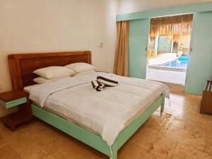 a bedroom with a bed with shoes on it at LAVENDER STAR HOUSE h in Kuta