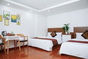 Rúm í herbergi á Sky House Hotel Da Lat City