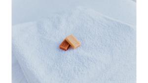 a small chocolate bar sitting on a white blanket at Belrose Estate by Tiny Away in Dumbalk