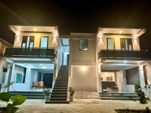 a large house with a staircase in front of it at Captain's Home Phong Nha in Phong Nha