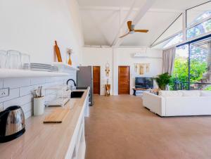a living room with a white couch and a table at Ocean Villa in Koh Phangan