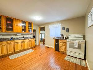 a kitchen with wooden cabinets and a stove at NEW - Mins to DHMC/ Hanover- House - Pet Friendly in Lebanon