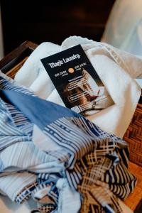 a box of clothes with a book on top of it at ARTOTEL Haniman Ubud in Ubud