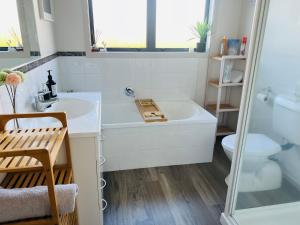 a bathroom with a tub and a toilet and a sink at Convenient in Cambridge in Cambridge +8 photos